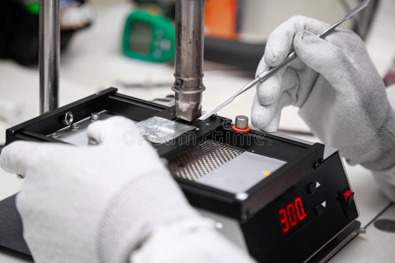 The Master Solders the Microchip at the Soldering Station. Service