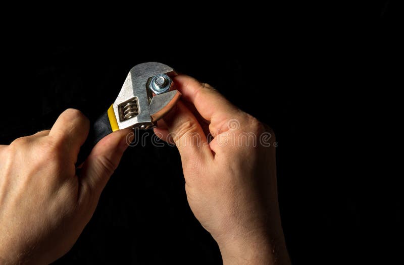 The master tighten the nut with a adjustable wrench in the bolt close up