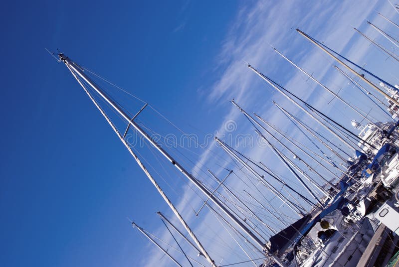 Beautiful sailboats moored to wharf at the harbor. Beautiful sailboats moored to wharf at the harbor