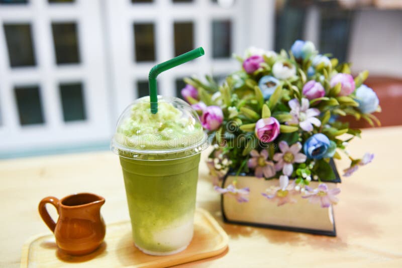 Ice Matcha Green Tea In Plastic Cup With Straw On Wooden Desk Stock Photo,  Picture and Royalty Free Image. Image 63010707.