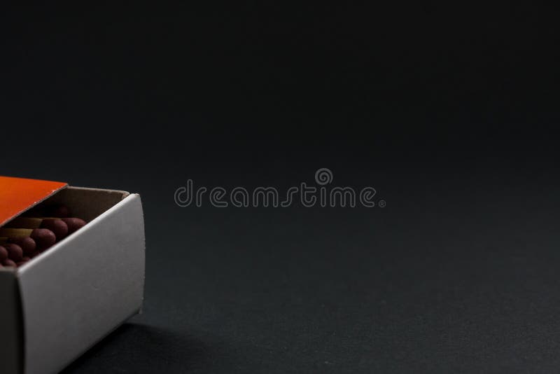 Matchbox Semiopen Showing Some Matches. Matches and Cardboard Box. Black Background Stock Image