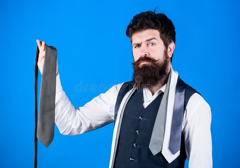 Matching his clothing style. Businessman in classic style. Bearded man choosing the right necktie for business life style. Brutal hipster wearing formal style with collection of ties.