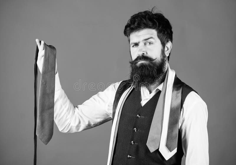 Matching his clothing style. Businessman in classic style. Bearded man choosing the right necktie for business life style. Brutal hipster wearing formal style with collection of ties.