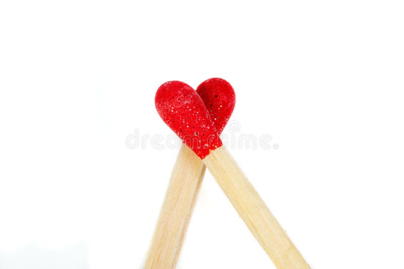 Matchstick with a red heart-shaped head on a white background. Close-up