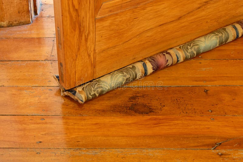 A Material Draught Stopper Under A Wooden Door Wood Worm