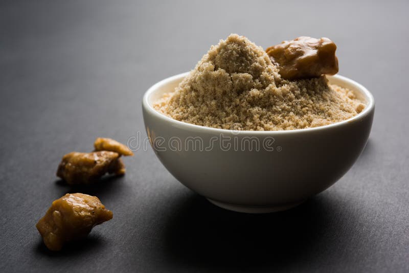 Asafoetida cake and powder or Hing or Heeng which is an important ingredient in Indian food recipes with big wooden spoon and mortar, selective focus. Asafoetida cake and powder or Hing or Heeng which is an important ingredient in Indian food recipes with big wooden spoon and mortar, selective focus