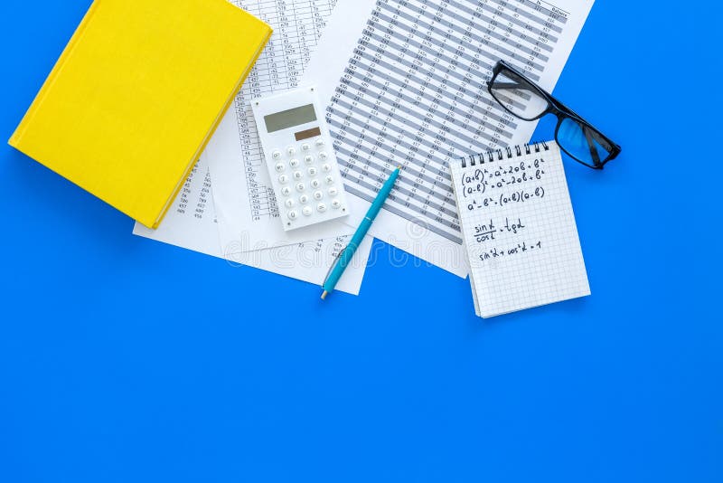 Math homework. Math textbook or tutorial near sheet with numbers, countes, calculator, notebook with formula on blue stock photos