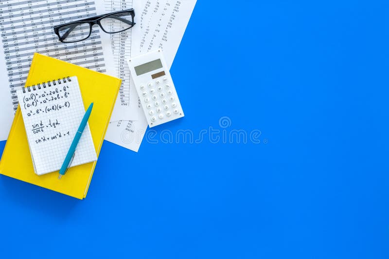 Math homework. Math textbook or tutorial near sheet with numbers, countes, calculator, notebook with formula on blue stock images