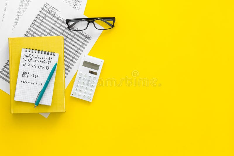 Math homework. Math textbook or tutorial near sheet with numbers, countes, calculator, notebook with formula on yellow stock images