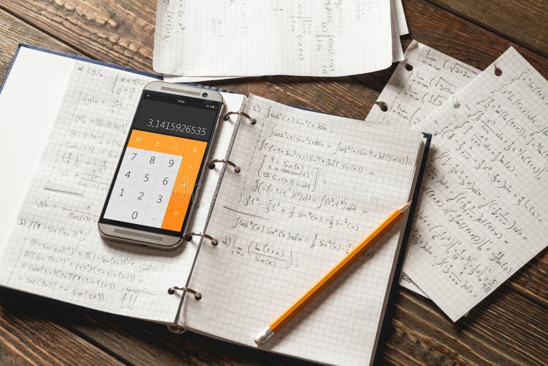 Mathematical equations written in a notebook. Calculator app.