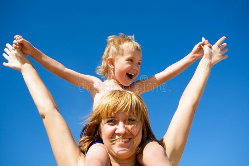 Mother and child(son) on a background of the blue sky.Summer.Wind. Mother and child(son) on a background of the blue sky.Summer.Wind.