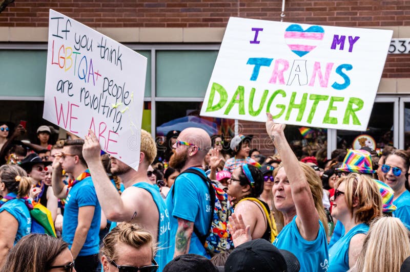 Lakeview, Chicago-June 30, 2019: A mother carries a sign that reads `I  my trans daughter` while marching in the Gay Pride parade. Lakeview, Chicago-June 30, 2019: A mother carries a sign that reads `I  my trans daughter` while marching in the Gay Pride parade