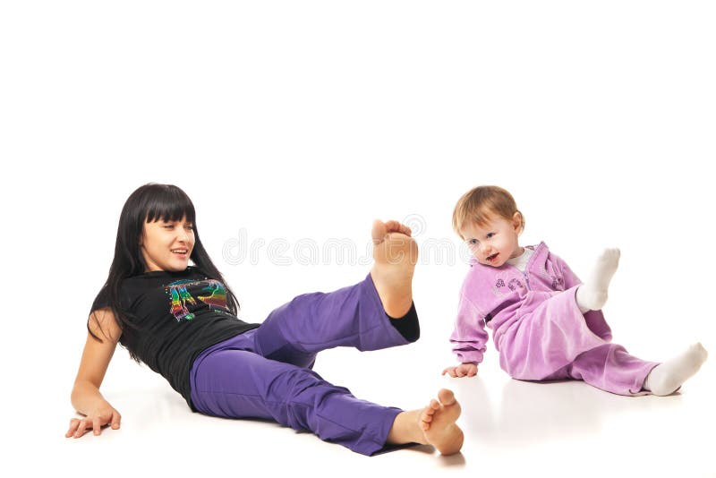 Yoga for women and child. Mother with the baby doing exercises. Yoga for women and child. Mother with the baby doing exercises