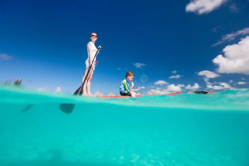 Mother and son paddling on stand up paddle board. Mother and son paddling on stand up paddle board