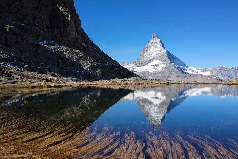 Matterhorn with reflection in lake with clear blue sky