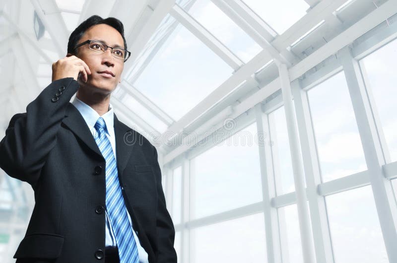 Mature Asian Businessman on Phone royalty free stock image