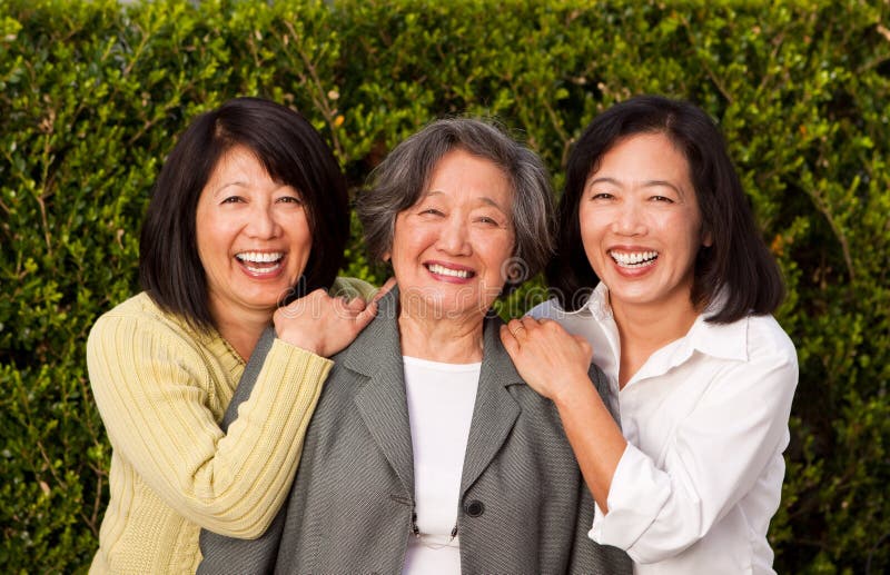 Mature Asian mother and her adult daughters. stock photo Mature Asian mother and her adult daughters. stock photo
