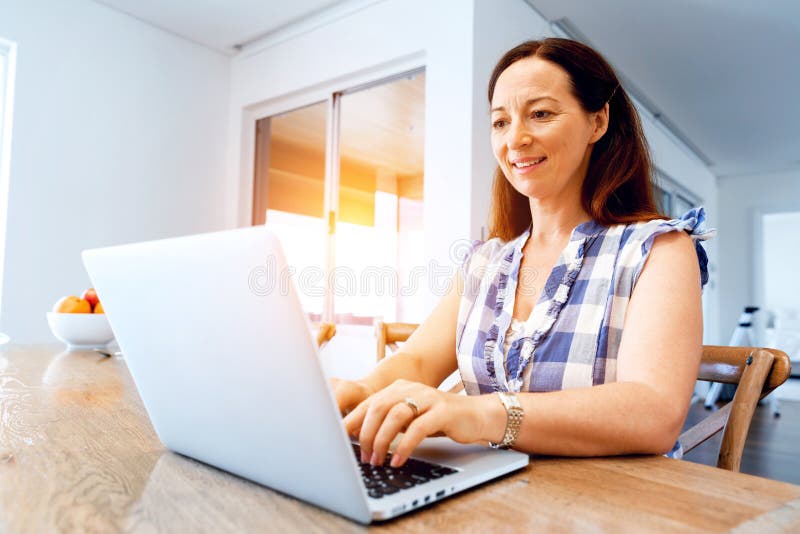 Mature beautiful woman working on her laptop