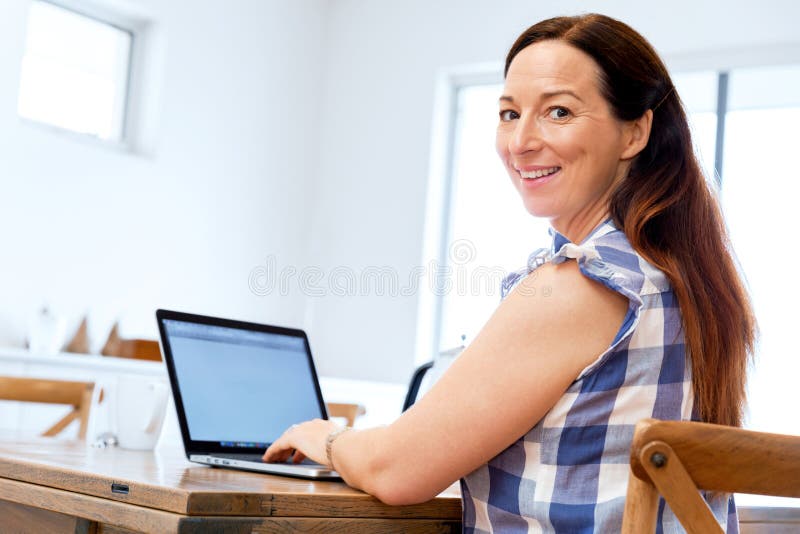Mature beautiful woman working on her laptop