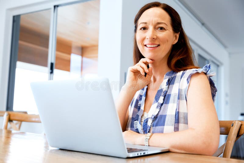 Mature beautiful woman working on her laptop