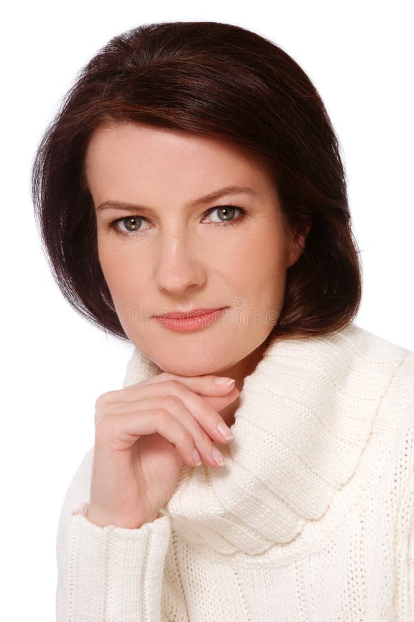 Portrait of attractive groomed healthy middle-aged woman in knitted pullover, over white background. Portrait of attractive groomed healthy middle-aged woman in knitted pullover, over white background