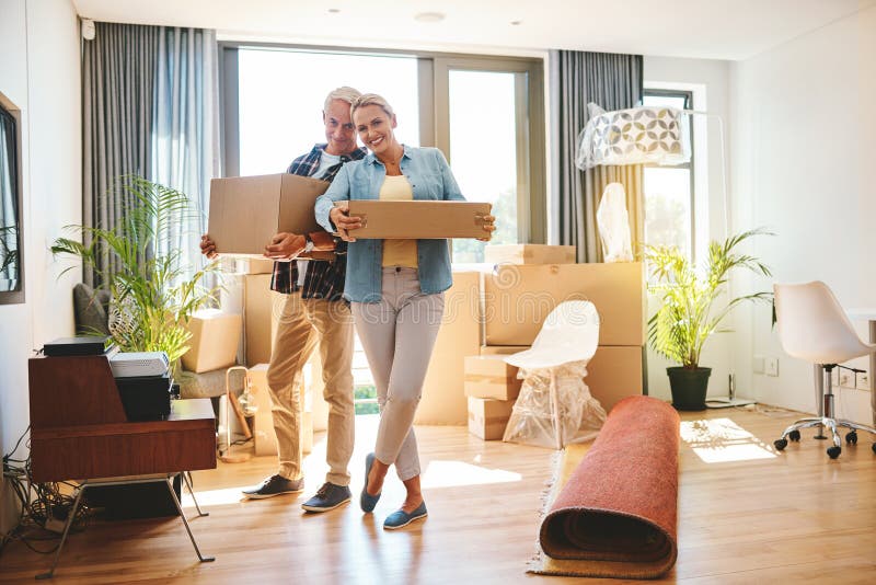 Mature, boxes and new home or moving out with living room, property or real estate support, help and excited. Happy stock image