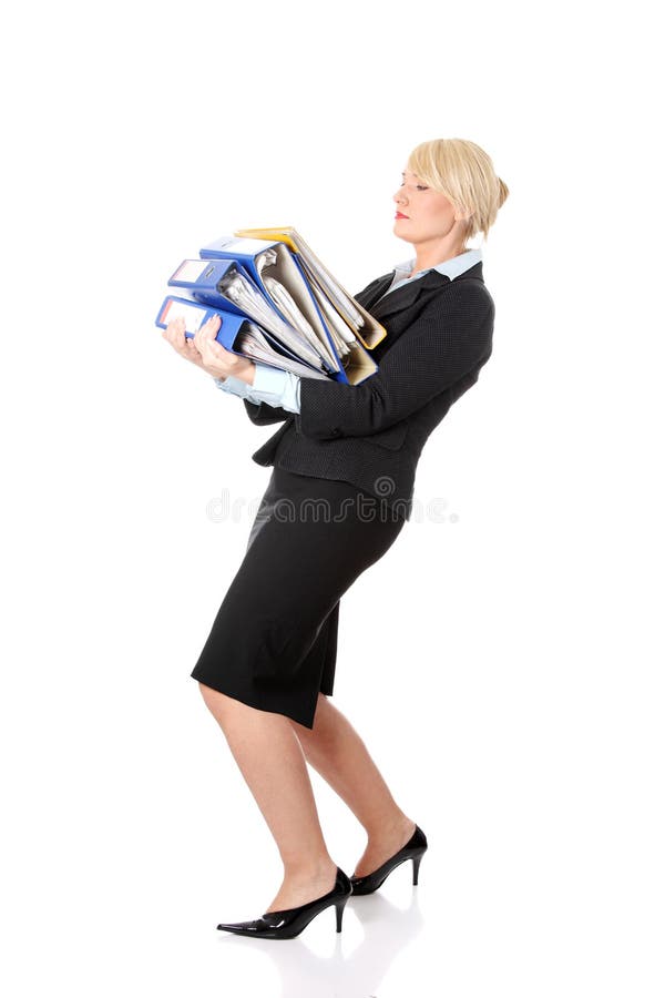 Barefoot mature businesswoman reading magazine while waiting for trip