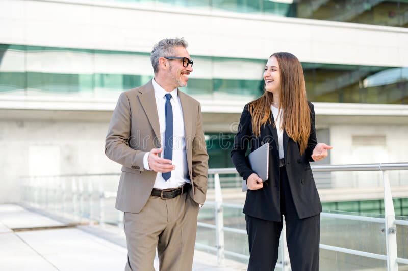 The mature businessman engages in an animated discussion with his female associate stock photo