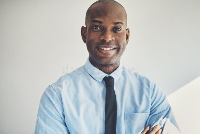 Mature businessman standing with his arms crossed in an office royalty free stock image Mature businessman standing with his arms crossed in an office royalty free stock image