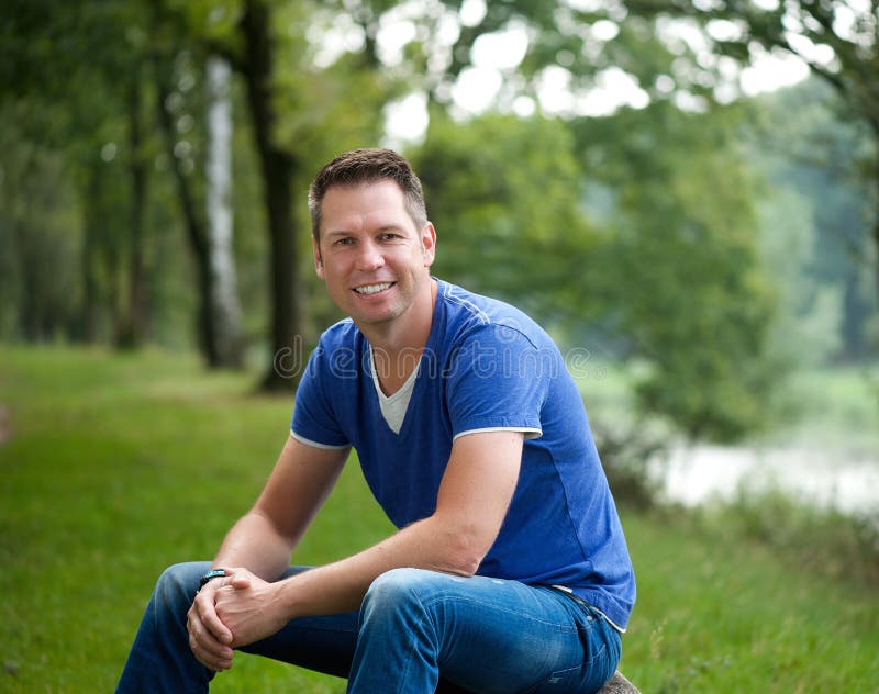 Mature caucasian man smiling outdoors stock photos