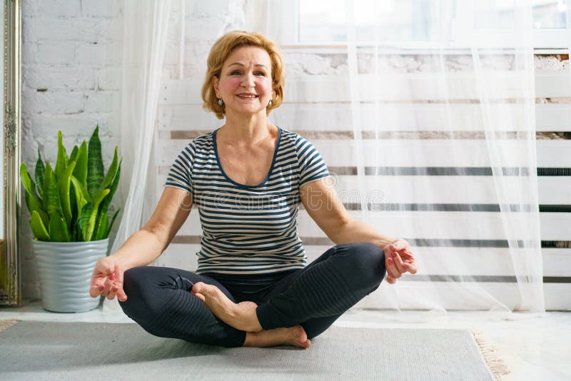 Mature Woman in Lotus Position at Home on Mat Stock Image - Image of ...