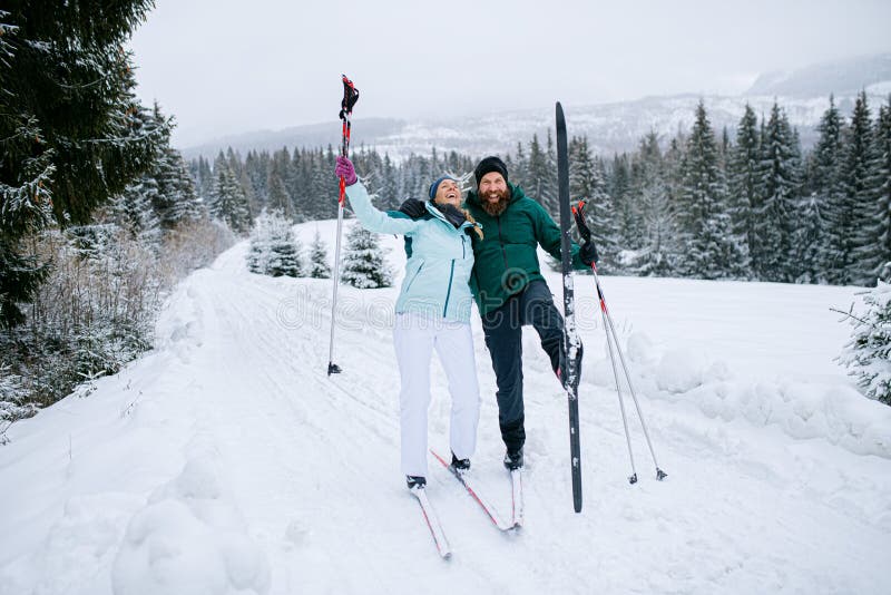 Mature couple cross country skiing outdoors in winter nature, Tatra mountains Slovakia.