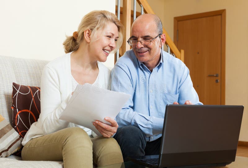 Mature couple with documents and notebook