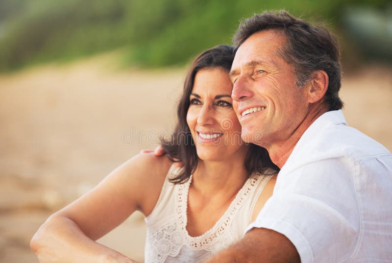 Mature Couple Enjoying Sunset on the Beach royalty free stock images