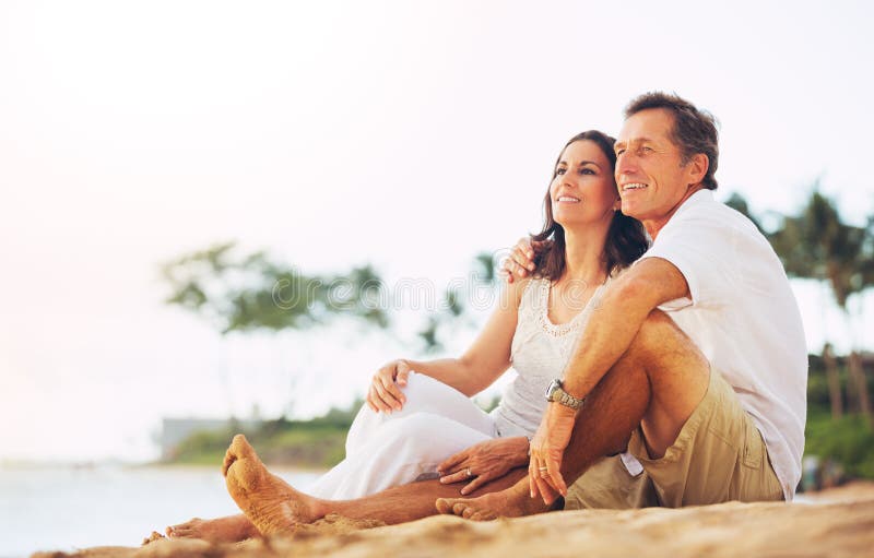 Mature Couple Enjoying Sunset on the Beach stock photography
