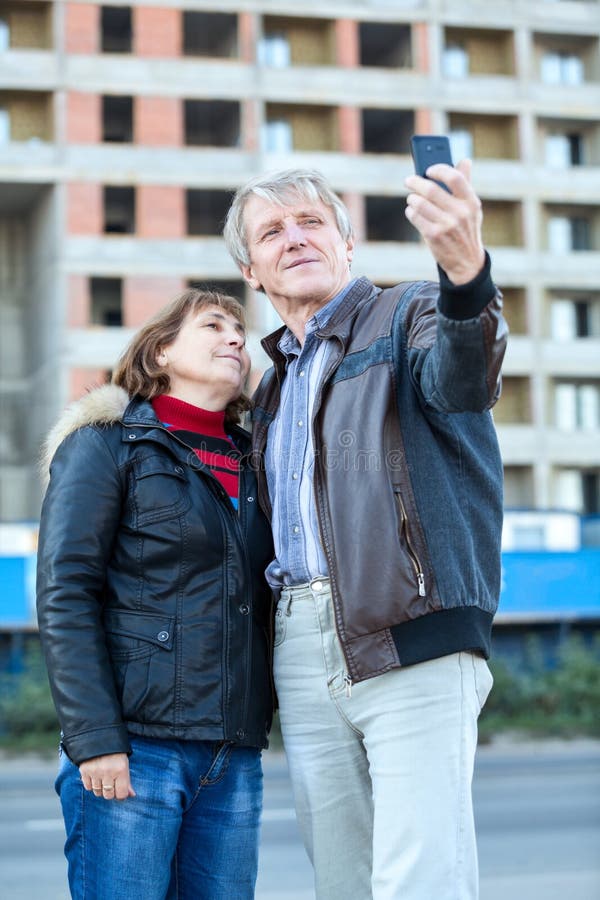 Mature Caucasian couple making selfie standing together. Joyful loving elderly couple stock images, royalty-free photos and pictures