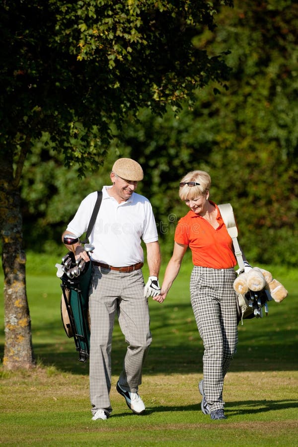 Mature couple playing Golf