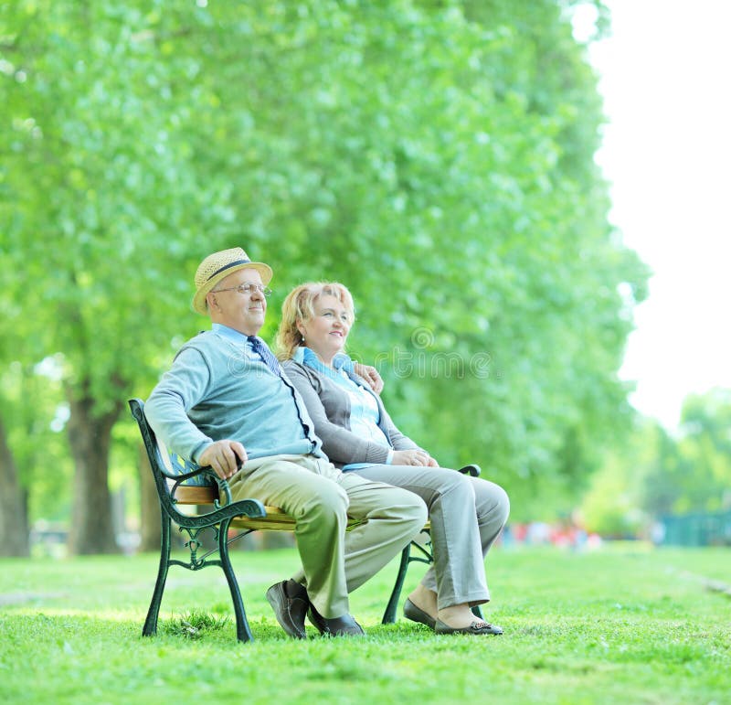 Older Couple Sitting Outside On Their Front Porch Steps Stock Photo