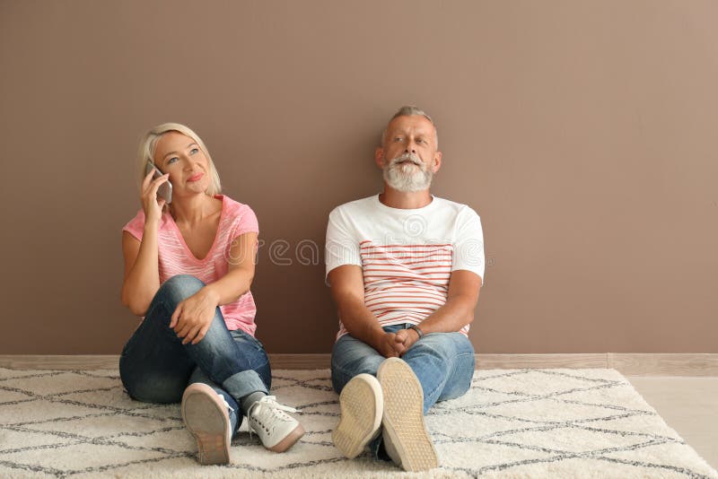 Married Mature Couple With Wineglasses Looking Forward Stock Photo