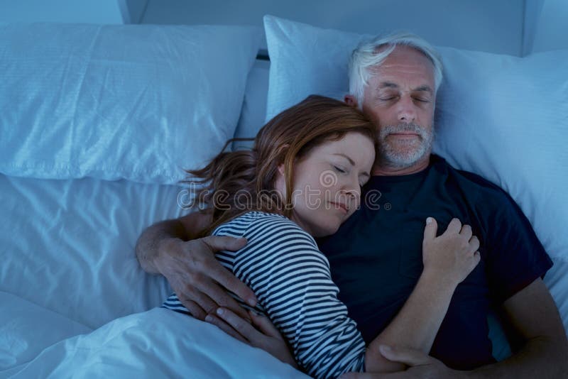 Mature couple sleeping at night