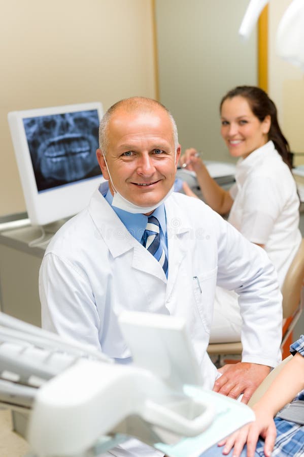 Mature Dental Surgeon in Office with Assistant Stock Image Image of
