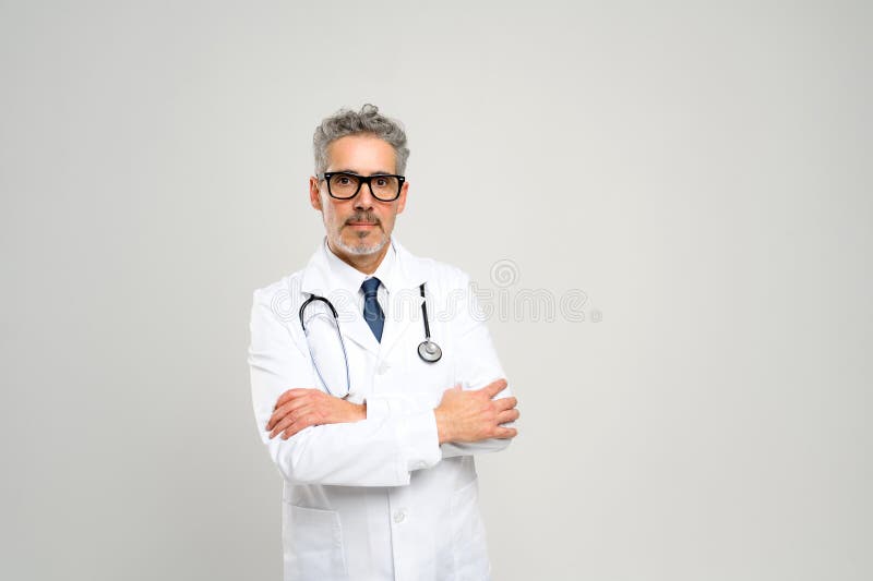 Experienced confident senior doctor with grey hair royalty free stock image