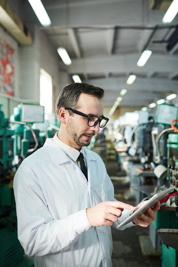Mature Factory Worker Holding Tablet royalty free stock images Mature Factory Worker Holding Tablet royalty free stock images
