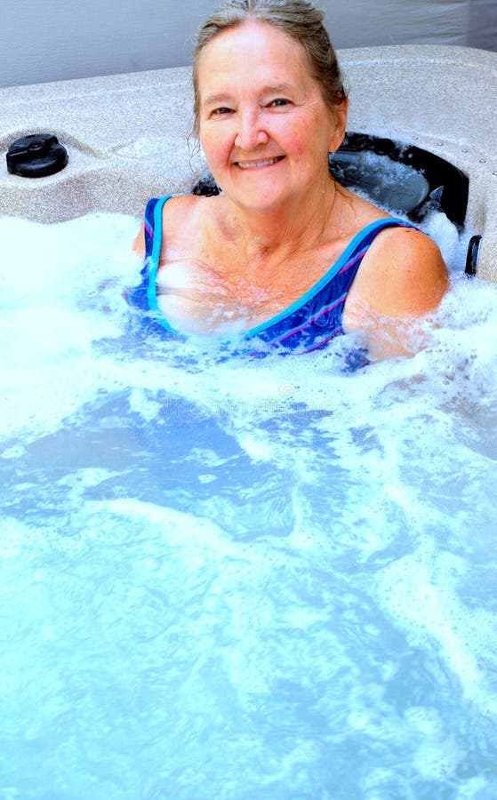 Mature female beauty relaxing in her hot tub. Mature female beauty relaxing in her hot tub.