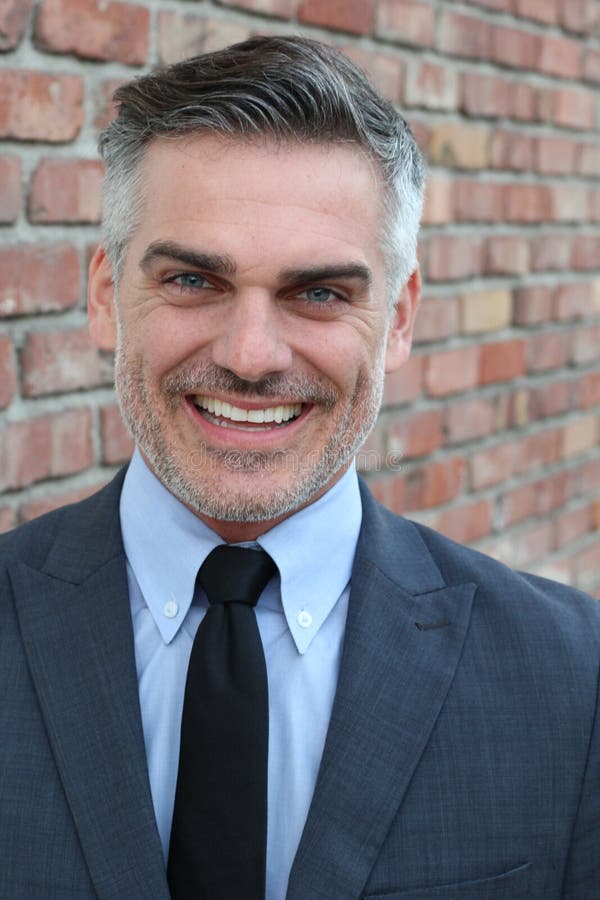 Mature handsome Caucasian businessman smiling