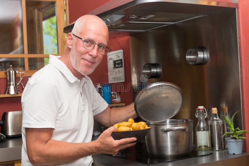 Mature man cook preparing hamburger middle aged, consumerism