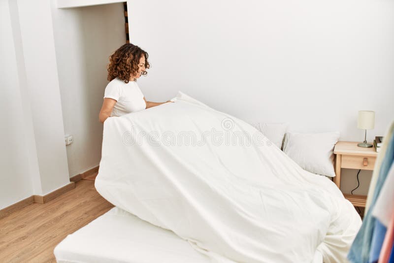 Mature Hispanic Woman Making the Bed at the Bedroom Stock Image Image