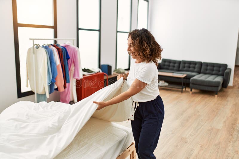 Mature Hispanic Woman Making the Bed at the Bedroom Stock Image Image