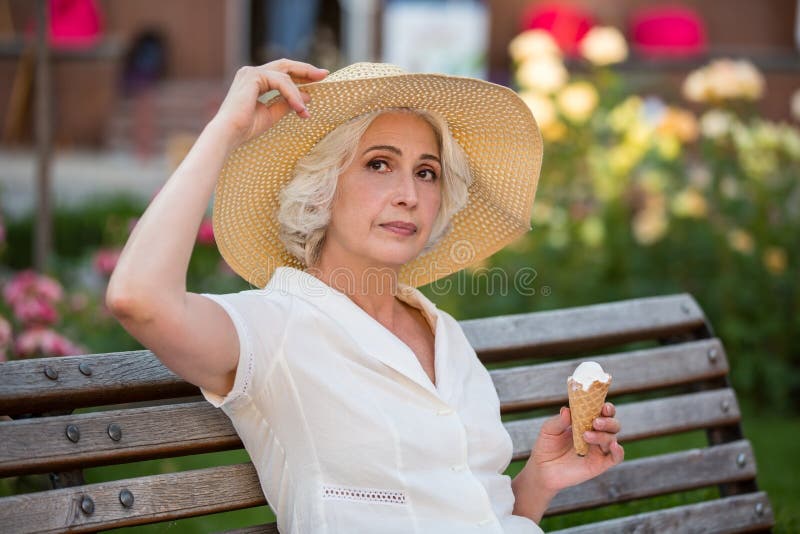 Mature lady with ice cream. royalty free stock photo Mature lady with ice cream. royalty free stock photo