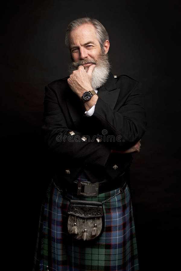 Mature male model wearing kilt with grey hairstyle and beard